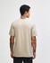 A unisex V-neck T-shirt in a beige colour, displayed from the back. The shirt features a logo.