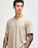 A unisex beige V-neck T-shirt with a relaxed fit, featuring a logo on the side.