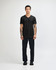 A black unisex V-neck T-shirt displayed on a model, featuring short sleeves and a fitted style.