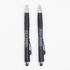 A pair of black pens with silver accents and branding, featuring rubber grips and stylus ends.