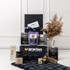 A picnic gift pack featuring a drink bottle, gourmet snacks, honey, and a checkered blanket in blue and black tones.