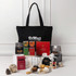A black tote bag with assorted gourmet treats, including chocolates, cookies, and a branded box. Various colours in packaging.