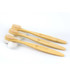 Three bamboo toothbrushes with light brown bristles, placed on smooth white stones. The handles feature a logo.