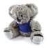 A plush toy koala with a soft, fuzzy texture, wearing a blue shirt.