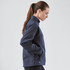 A navy women's Cirrus Bonded Jacket with a high collar and zippered pockets, featuring a logo.