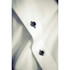 A close-up of a white button-up shirt featuring black buttons and a subtle texture, with a branding logo visible.