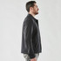 A men's jacket in dark grey, featuring a sleek design and a minimalistic look, with a logo present.
