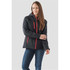 A woman wearing a black insulated softshell jacket with red accents and a hood, standing against a neutral background.