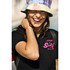 A black women's cotton polo shirt featuring a logo, worn by a woman smiling, with a tie-dye bucket hat.
