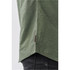 A close-up of a green button-up shirt with a textured finish, featuring a logo at the hem.