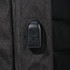 A close-up of a feature on a black backpack, showcasing a zipper pull and textured fabric.