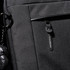 A black laptop sleeve with a zippered pocket and a branded tag. Features a keychain accessory attached.