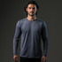 A long-sleeve grey t-shirt on a model, featuring a logo. The fabric appears lightweight and suitable for active wear.