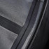 A close-up of a black softshell jacket, showcasing its fabric texture and zipper detail. It features a logo on the fabric.