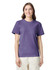 A woman is wearing a purple heavyweight T-shirt. The shirt has a logo and is styled with a relaxed fit.