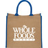 A large beige jute tote bag with blue handles and a logo on the front.
