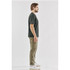 A side view of a man wearing a black Men's Settebello Tee paired with olive green trousers and white sneakers.
