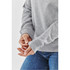 A grey women's henley shirt with long sleeves, featuring a relaxed fit and cuffed wrists.