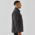 A men's black oxide Sherpa lined canvas jacket with a collar and side pocket, shown from a profile view.
