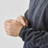 A men's fleece jacket in dark grey, featuring a full zip and fitted cuffs. The jacket has a logo on it.