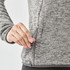 A grey women's full zip fleece jacket featuring a side zip pocket and a textured fabric design.