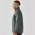 A side view of a man wearing a men's thermal jacket in a dark green colour. The jacket features a high collar and has a logo.