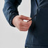 A person’s hand adjusts the zippered pocket of a Women's Pacifica Thermal Jacket in navy blue. The jacket features a sleek design.