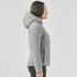 A woman in a light grey puffer jacket with a hood, standing in profile. The jacket features a fitted design.