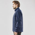 A navy blue softshell jacket with quilted design and zip pockets, featuring a logo on the chest.