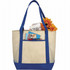 A beige tote bag with blue handles, holding magazines, a notepad, and flowers, featuring a logo.