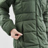 A green women's puffer jacket with a zipper pocket and quilted texture, featuring a person’s hand interacting with it.