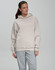 A unisex premium fleece oversized hoodie in a light beige colour with a large kangaroo pocket and a hood.