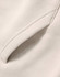 A close-up of a cream-coloured premium fleece oversized hoodie featuring a side seam pocket.