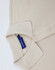A beige short-sleeve polo shirt with a collar and buttons, featuring a brand logo tag.