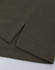 A close-up of a short-sleeved polo in an olive green cotton/poly pique fabric with a stitched hem.