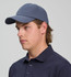 A cotton twill unstructured cap in navy blue, featuring a curved brim and an adjustable strap at the back.