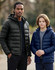 Two models wearing lightweight puffer jackets; one in black and the other in navy blue, both with hoods.