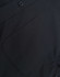 A black cotton blend long-sleeve shirt featuring a chest pocket and button detail. It also has a logo.