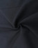 A close-up of a black cotton blend fabric showing its texture and smoothness, featuring a subtle swirl pattern.