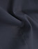 A close-up of navy cotton blend fabric, highlighting a textured weave with subtle folds.