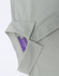 A light green men's polo shirt with a collar, showcasing a tag and button detail. It features branding on the tag.