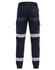 Cuffed work pants in navy with reflective tape and multiple pockets. Features an elastic waistband at the back.