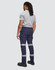 Flexi work pants in navy with reflective tape details, worn by a person seen from the back. Features a logo.