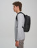 A black Elite PU backpack is shown worn on the back of a person in a grey long-sleeve shirt.
