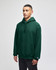 A green hooded sweatshirt with a front pocket and a logo on the sleeve, worn by a model.