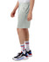 A light green pair of athletic shorts worn by a person, paired with sporty shoes and striped socks.