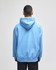A light blue pullover hooded sweatshirt with a hood and a relaxed fit, featuring a logo on the back.