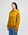 A mustard yellow pullover hooded sweatshirt with a front pocket and a logo on the sleeve.