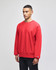A red sweatshirt with long sleeves and a crew neckline, featuring a logo on the sleeve.
