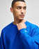 A blue Champion Reverse Weave® adult crew sweatshirt featuring a logo on the sleeve.